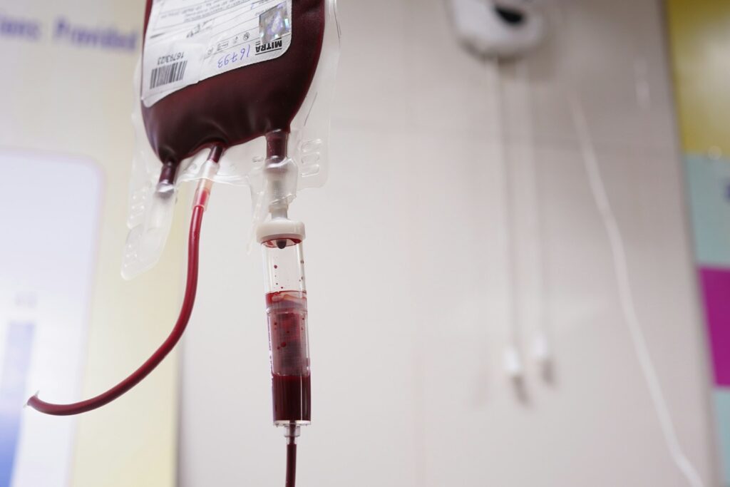 Blood bag hanging in a clinical setting, illustrating blood donation